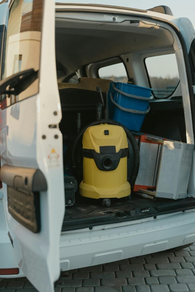 A well-organized cleaning van with equipment in the cargo area.